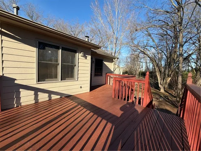 a view of a roof deck with wooden floor and fence