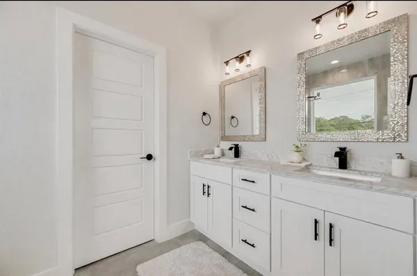 a bathroom with a double vanity sink and mirror