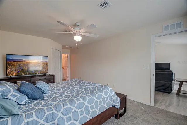 a bedroom with a bed and a flat screen tv