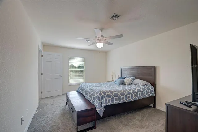 a bedroom with a bed and a window in it