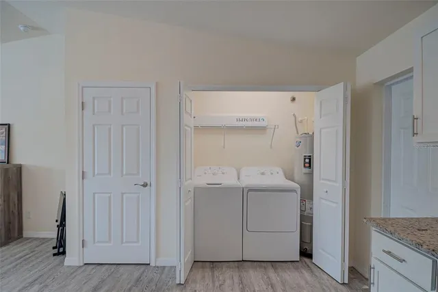 a utility room with cabinets washer and dryer