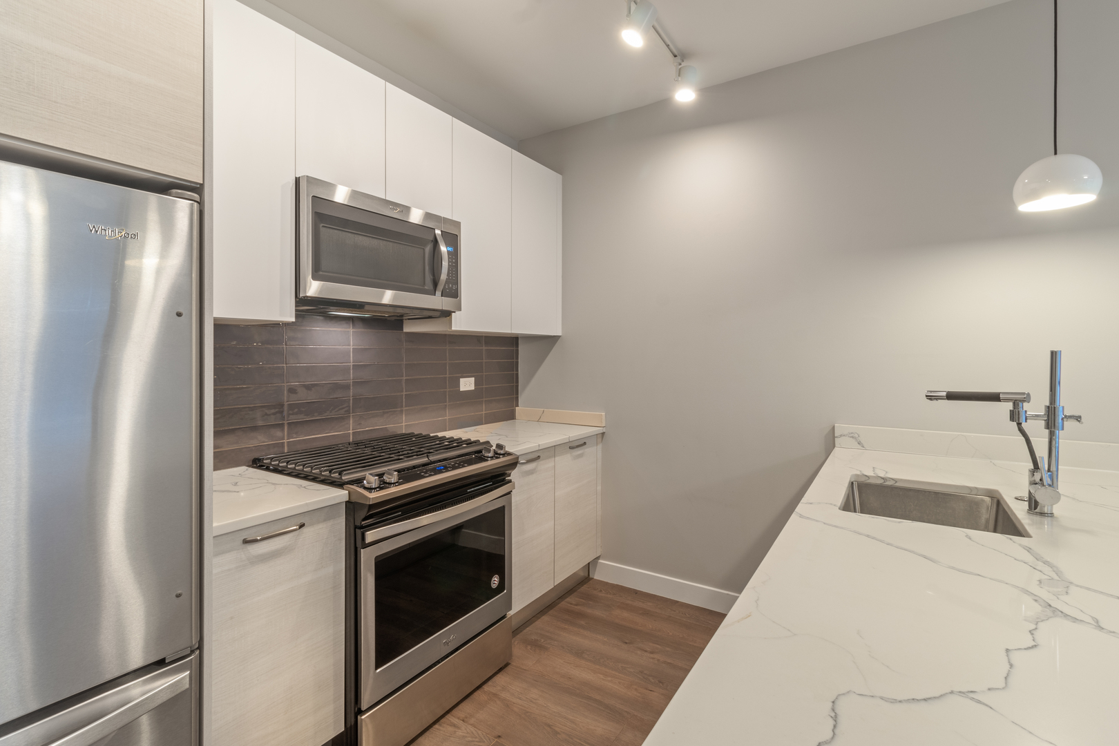Undisclosed Address Chicago, IL 60610 - Photo 4 of 13 a kitchen with a stove microwave and sink