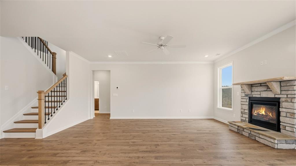 1780 Goodwin Drive Hampton, GA 30228 - Photo 14 of 40 a view of an empty room with wooden floor fireplace and a window