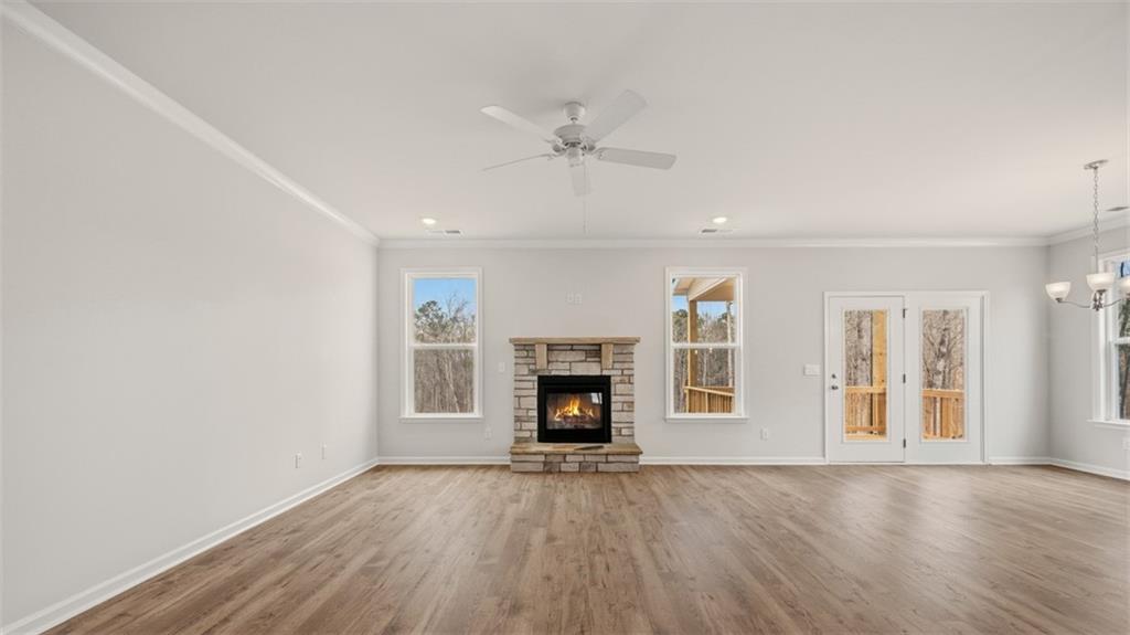 1780 Goodwin Drive Hampton, GA 30228 - Photo 15 of 40 an empty room with fireplace cabinet and windows
