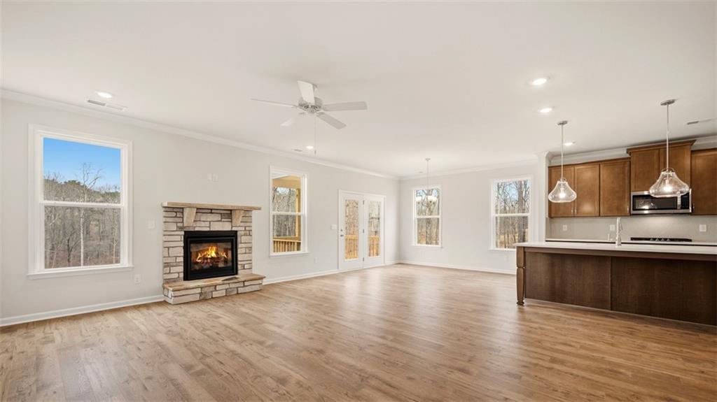 1780 Goodwin Drive Hampton, GA 30228 - Photo 17 of 40 a view of empty room with wooden floor and a fireplace