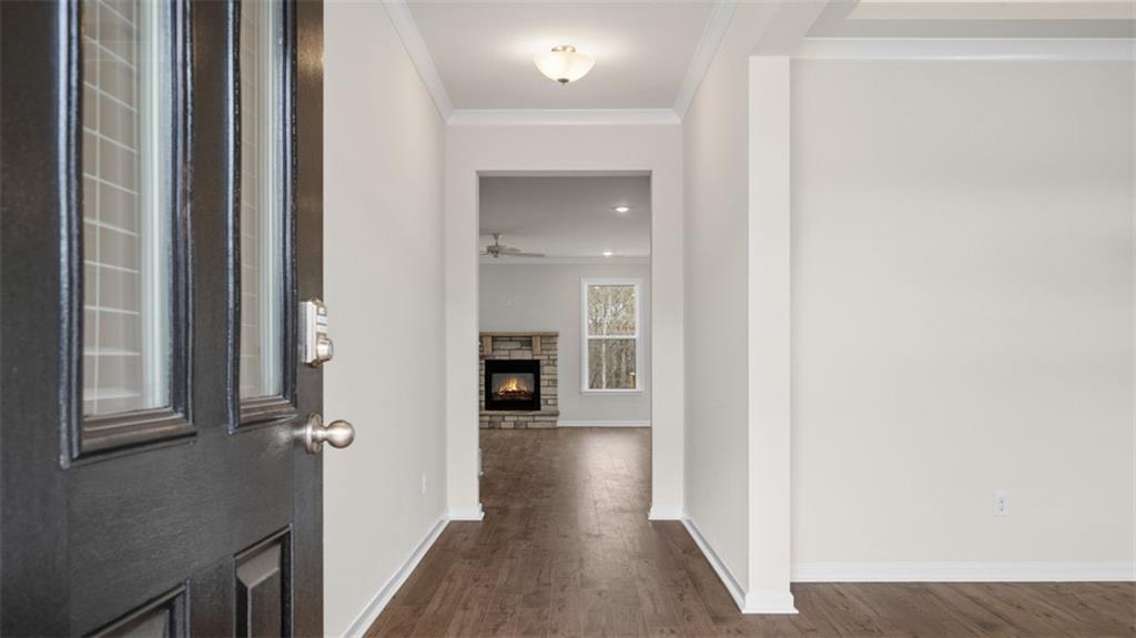 1780 Goodwin Drive Hampton, GA 30228 - Photo 6 of 40 a view of a hallway with wooden floor and staircase