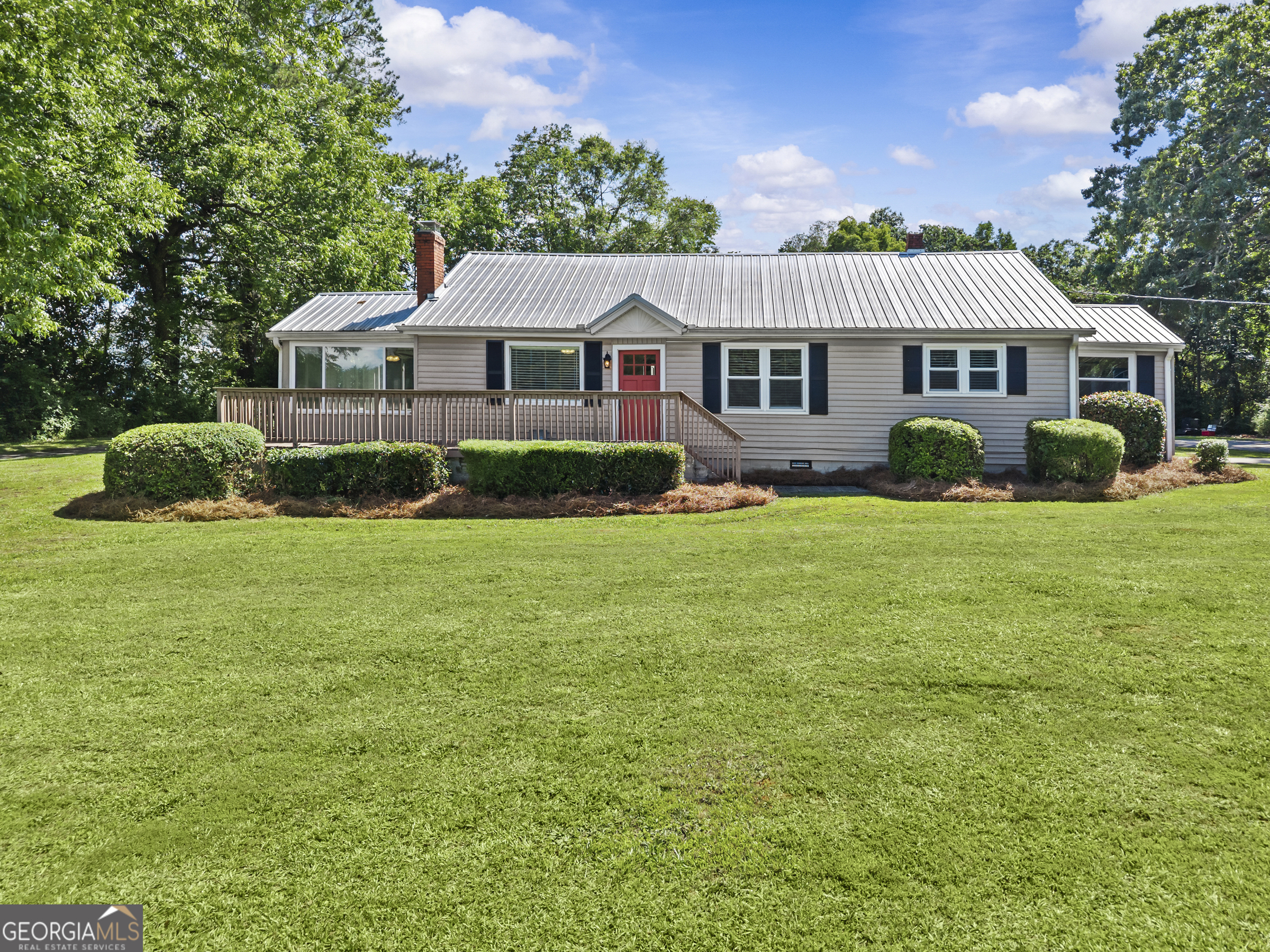 a front view of a house with garden