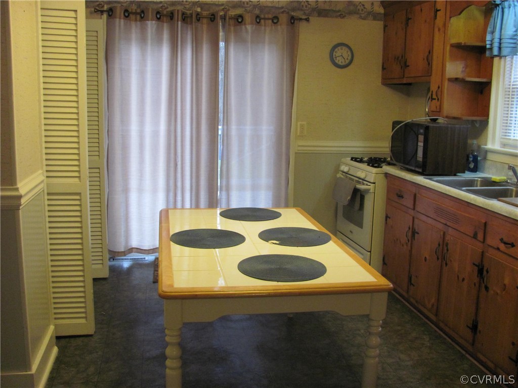 16160 Tyler Station Road Beaverdam, VA 23015 - Photo 6 of 17 a kitchen with a sink and a refrigerator