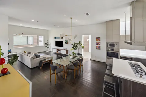 a view of a dining room with furniture and wooden floor