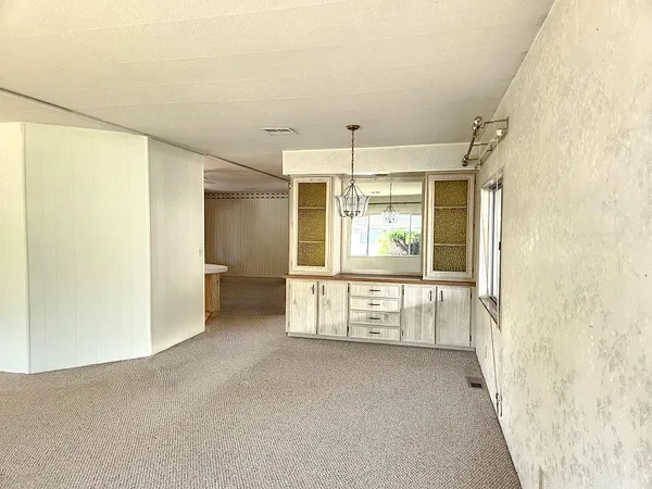 a kitchen with white cabinets a sink stove and refrigerator