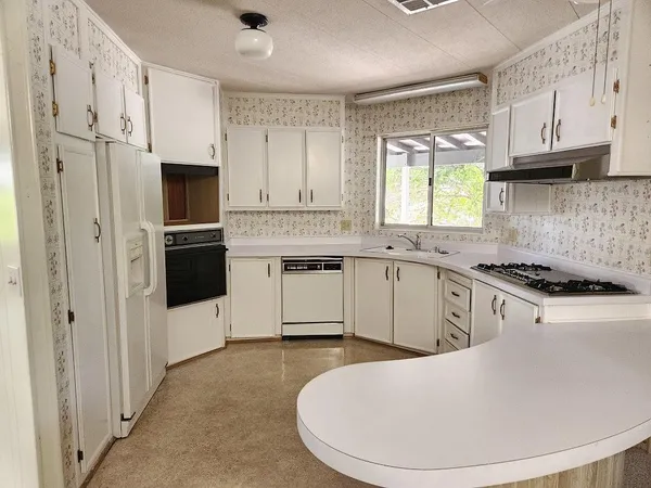 a kitchen with stainless steel appliances a refrigerator sink and stove
