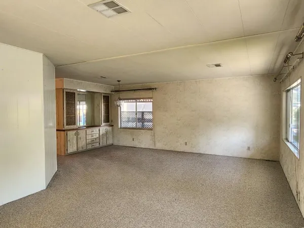 an empty room with windows and pillars in it