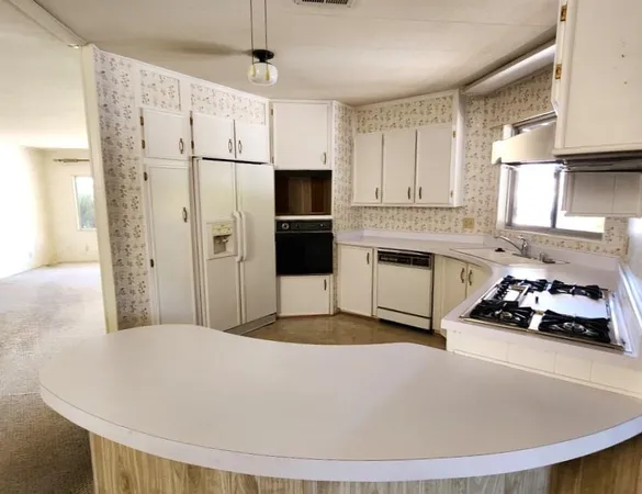 a kitchen with stainless steel appliances a refrigerator sink and stove