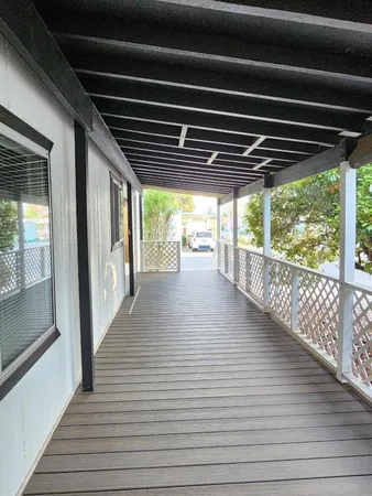 a view of backyard with deck and outdoor seating