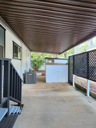 a view of a yard with plants and trees