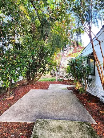 a pathway of a house with a yard