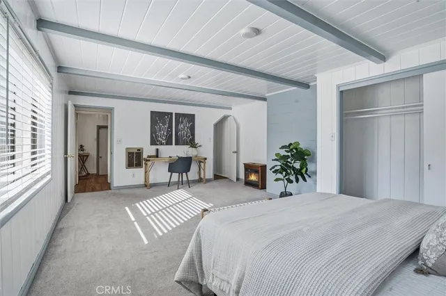 a bedroom with a large bed and potted plant