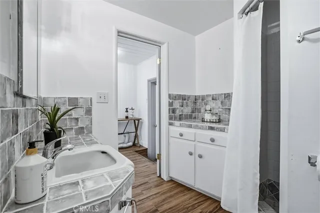 a spacious bathroom with a granite countertop tub sink and mirror
