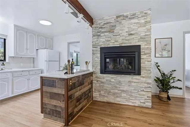 a kitchen with sink cabinets and fireplace