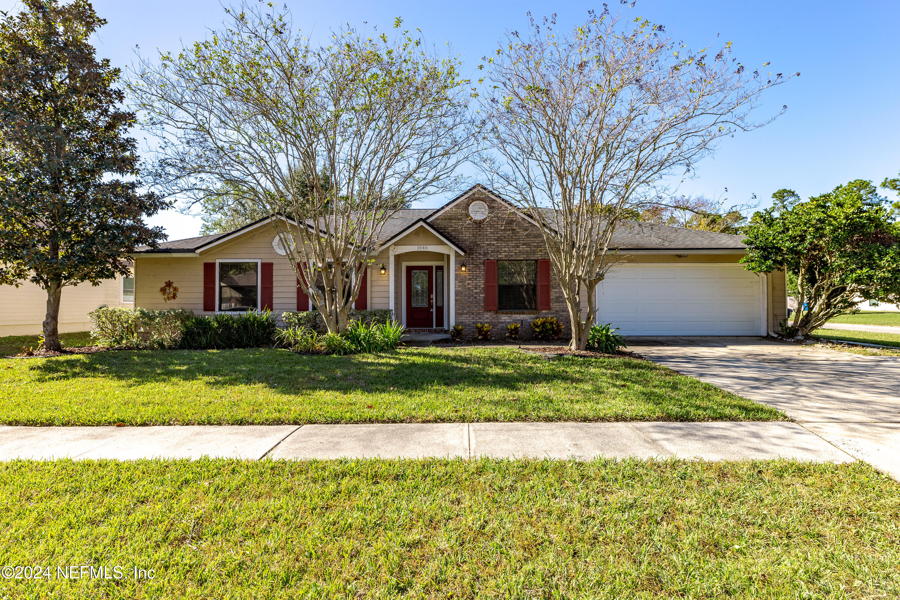 1646 Rusty Rail Road Jacksonville, FL 32225 - Photo 1 of 31 a front view of a house with a yard and garage