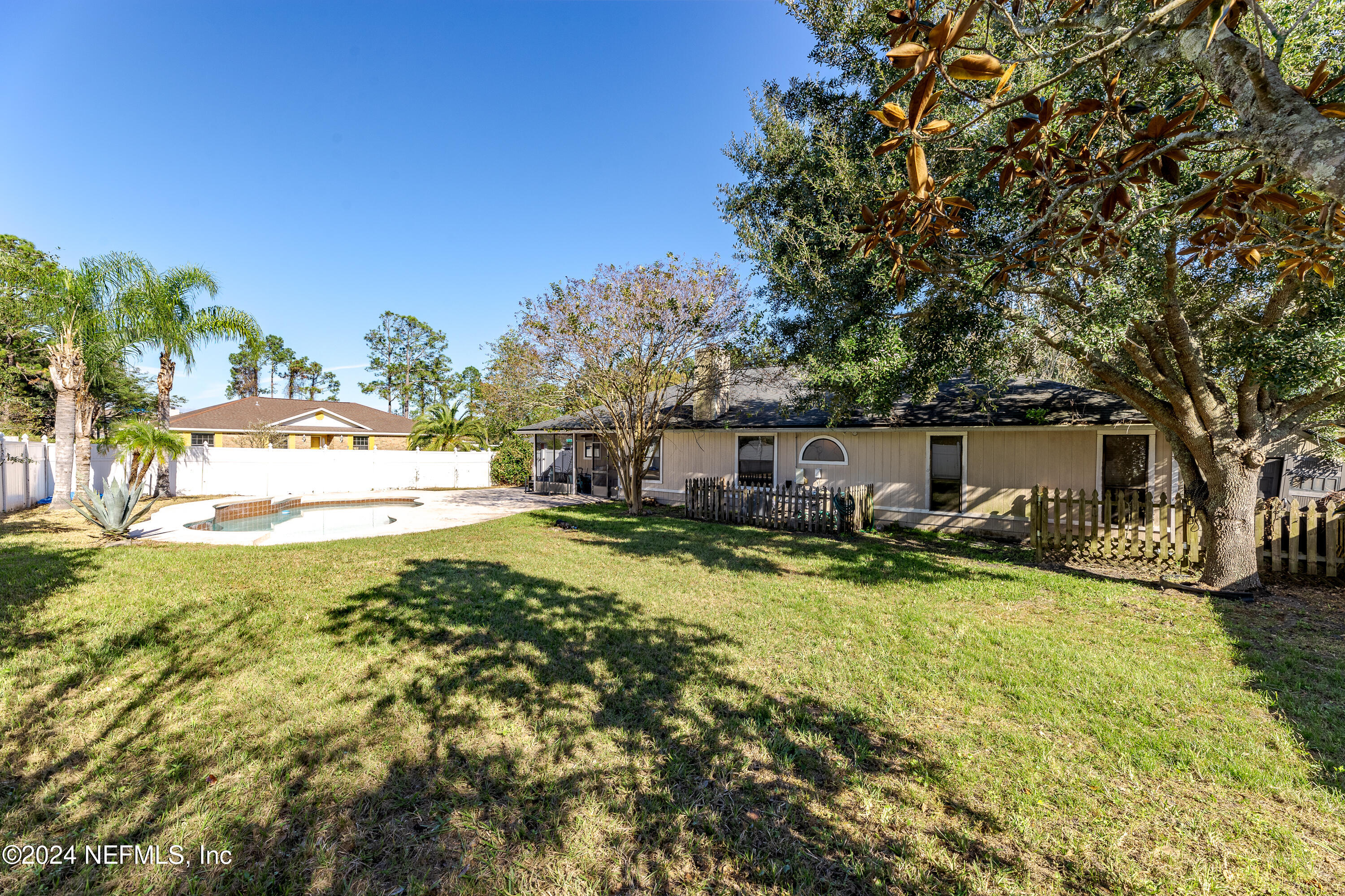 1646 Rusty Rail Road Jacksonville, FL 32225 - Photo 15 of 31 a view of a house with a big yard and large trees