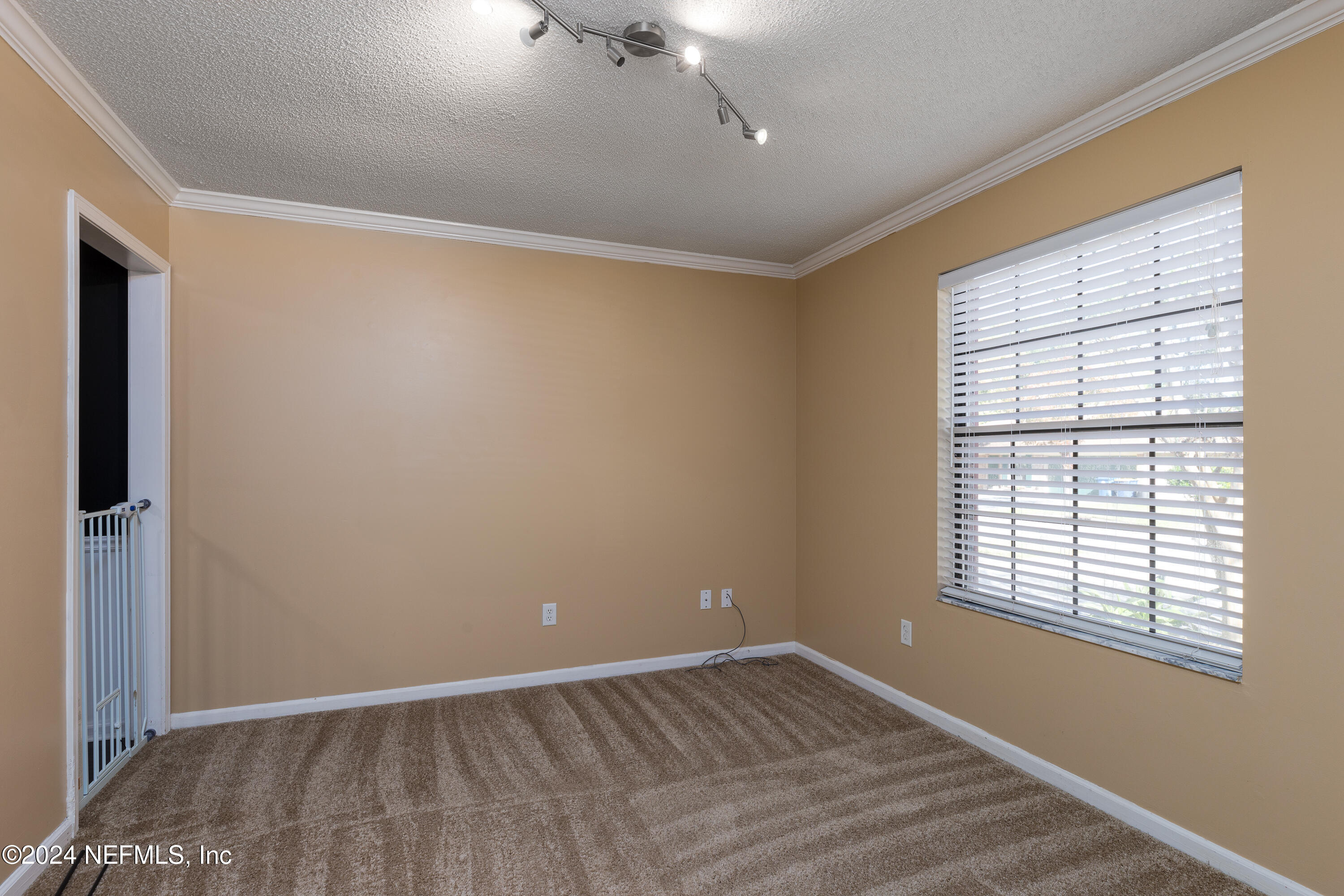1646 Rusty Rail Road Jacksonville, FL 32225 - Photo 20 of 31 a view of an empty room with wooden floor and a window