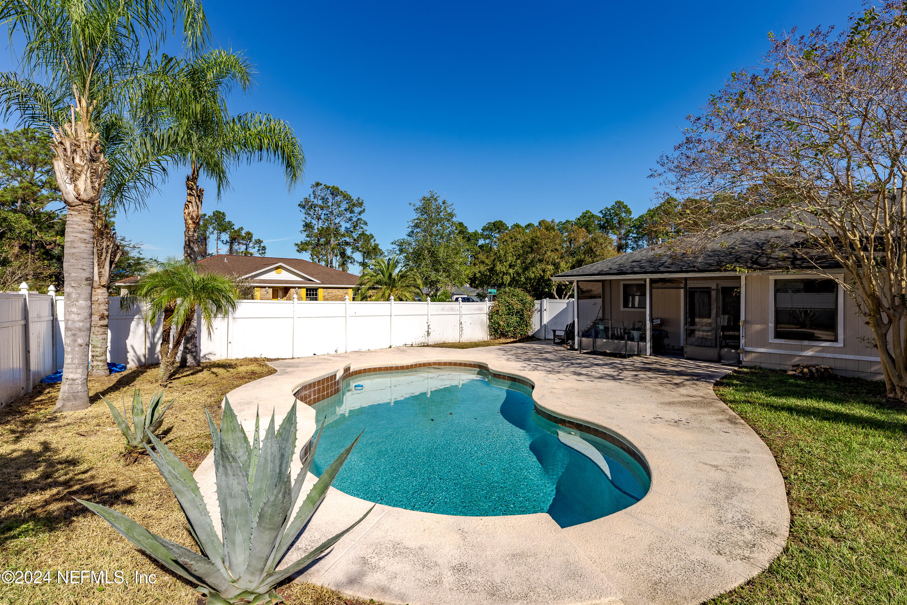 1646 Rusty Rail Road Jacksonville, FL 32225 - Photo 2 of 31 a view of a swimming pool with a garden