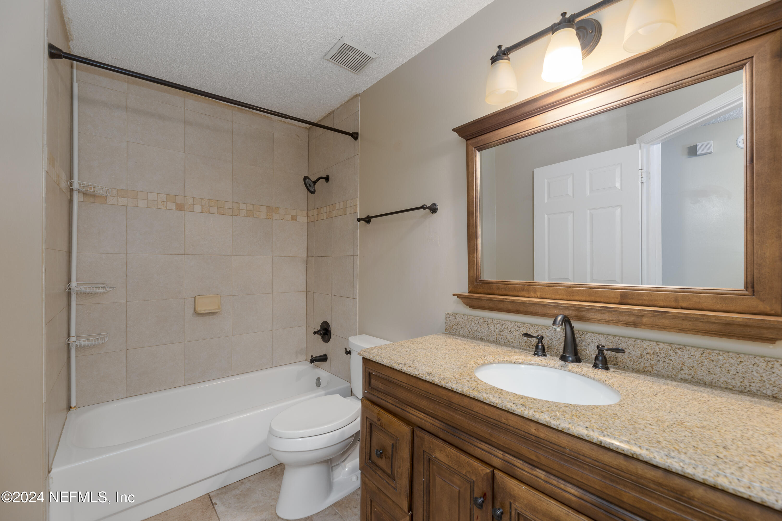 1646 Rusty Rail Road Jacksonville, FL 32225 - Photo 25 of 31 a bathroom with a granite countertop sink toilet and shower
