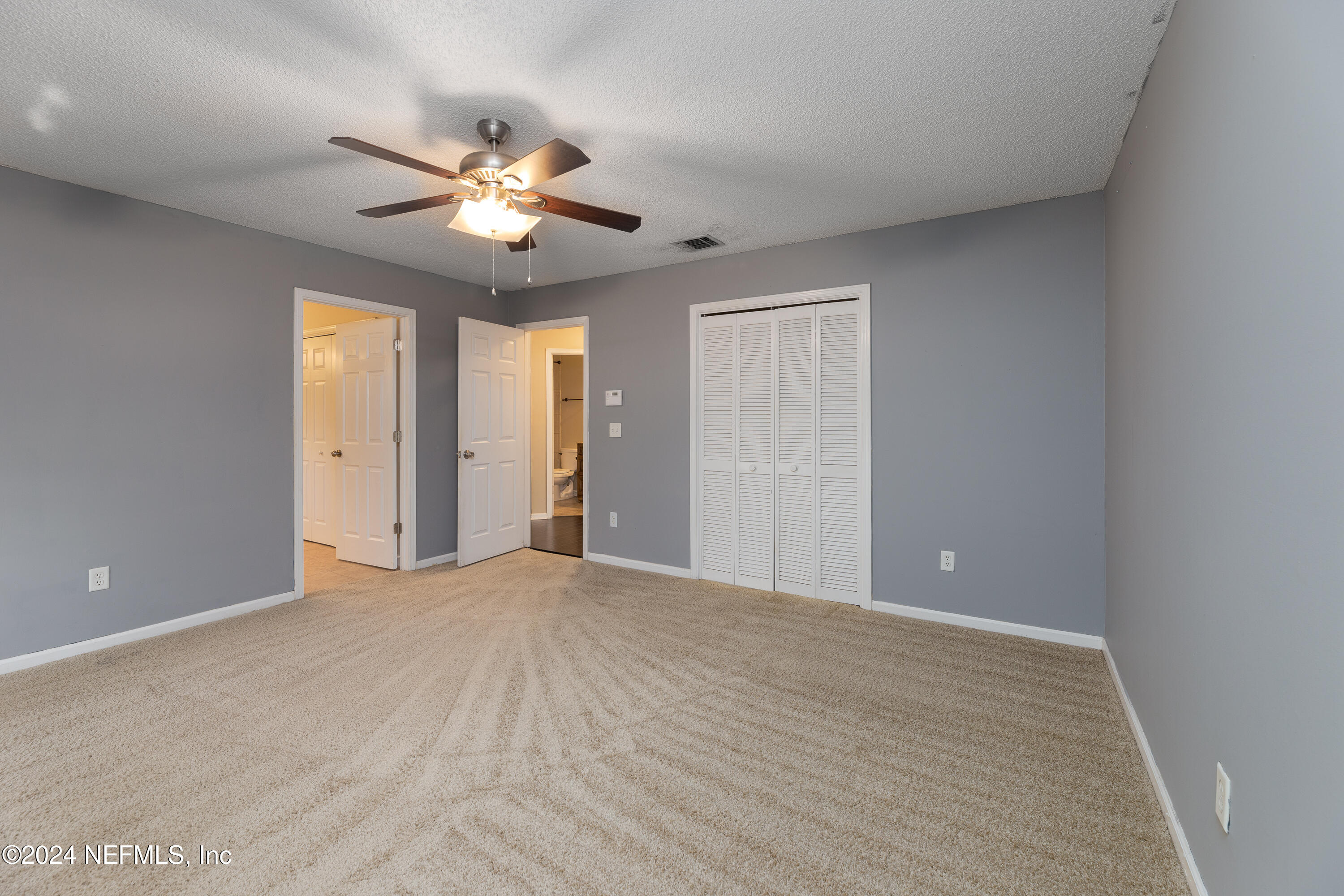 1646 Rusty Rail Road Jacksonville, FL 32225 - Photo 27 of 31 a view of an empty room with a ceiling fan and window