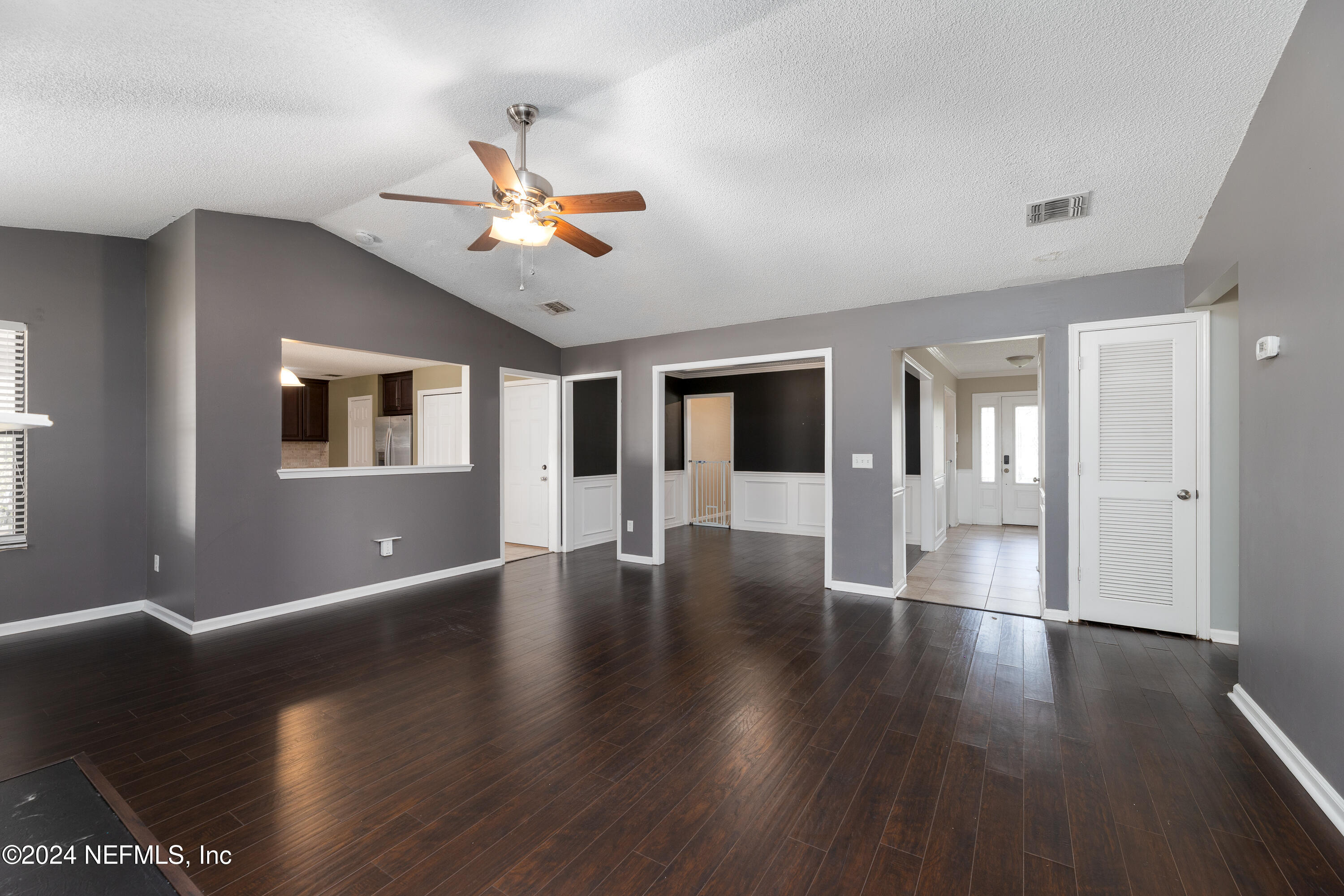 1646 Rusty Rail Road Jacksonville, FL 32225 - Photo 4 of 31 a view of an empty room with wooden floor and a ceiling fan
