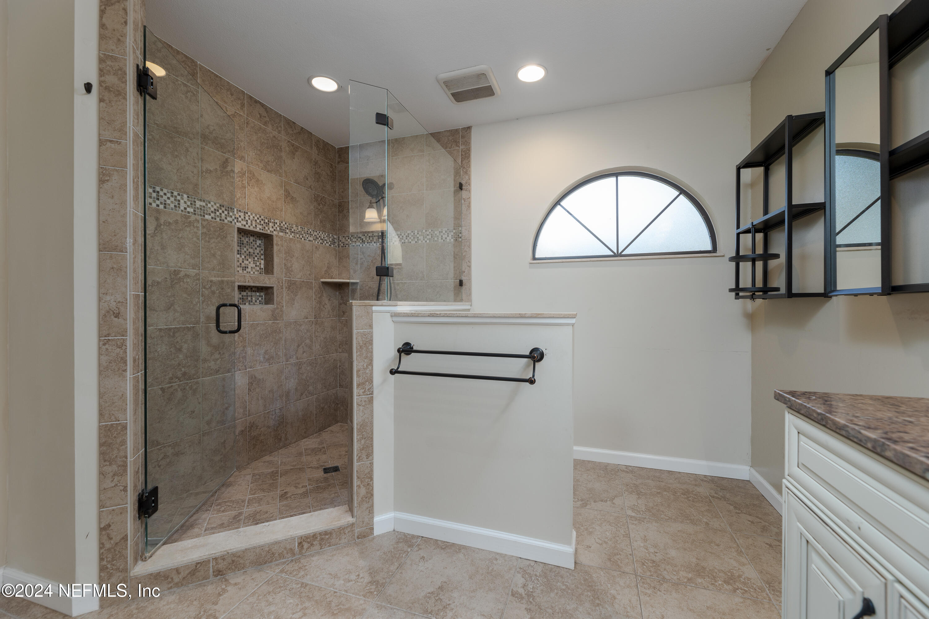 1646 Rusty Rail Road Jacksonville, FL 32225 - Photo 9 of 31 a bathroom with a mirror a shower and a glass door