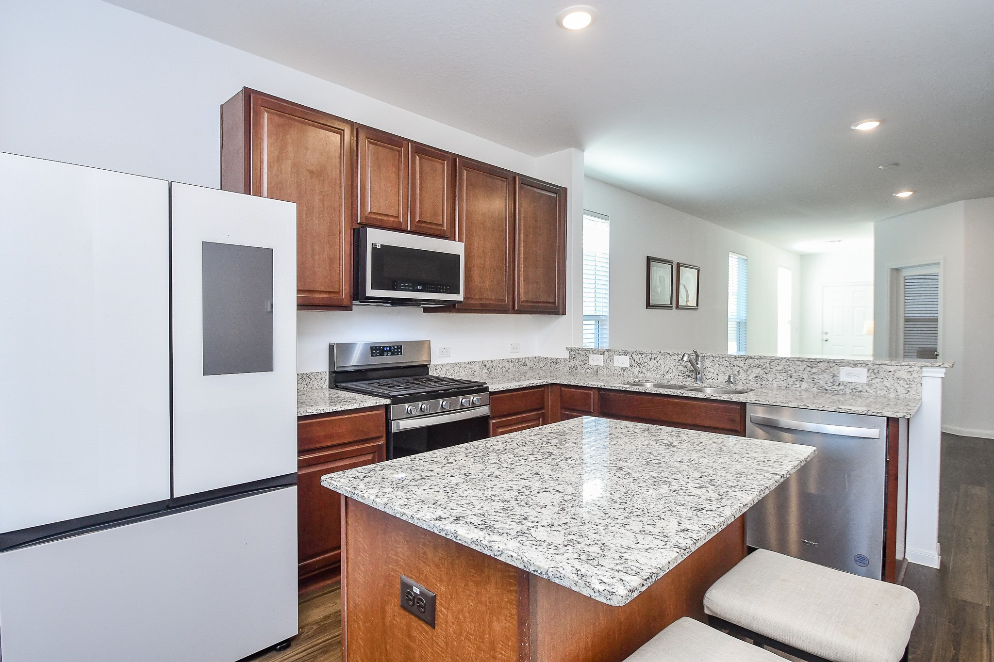 17826 Juneberry Seed Street Hockley, TX 77447 - Photo 15 of 35 a kitchen with stainless steel appliances granite countertop a sink refrigerator and microwave