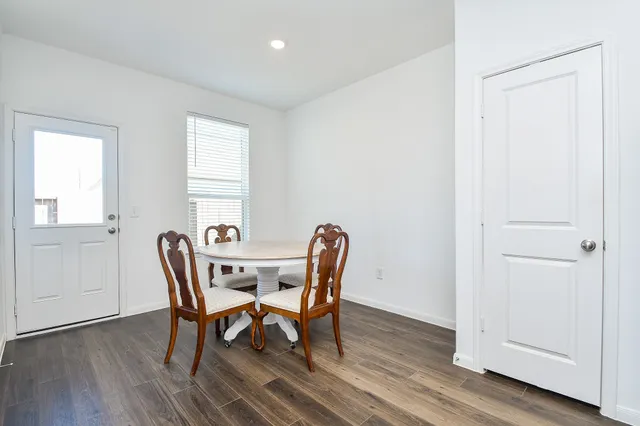 a view of kitchen island with wooden floor and chairs