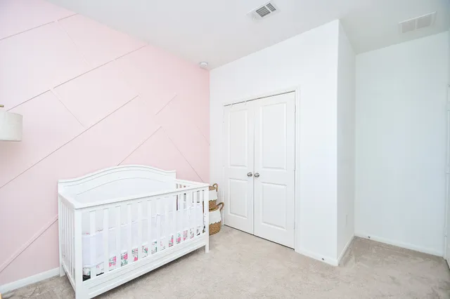 a spacious bedroom with a bed and a window