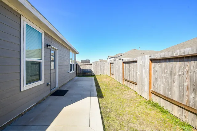 a view of a house with wooden floor and a yard