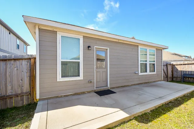 a view of a house with backyard and sitting area