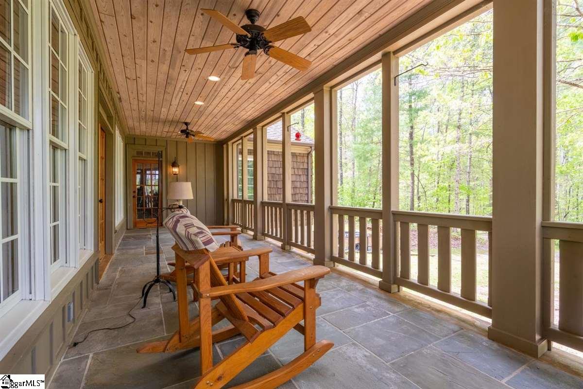 185 Hemlock Cove Road Sunset, SC 29685 - Photo 32 of 36 Lots of room for rocking chairs to enjoy the oasis of your private back yard. The door at the end of the porch provides access to the master suite.