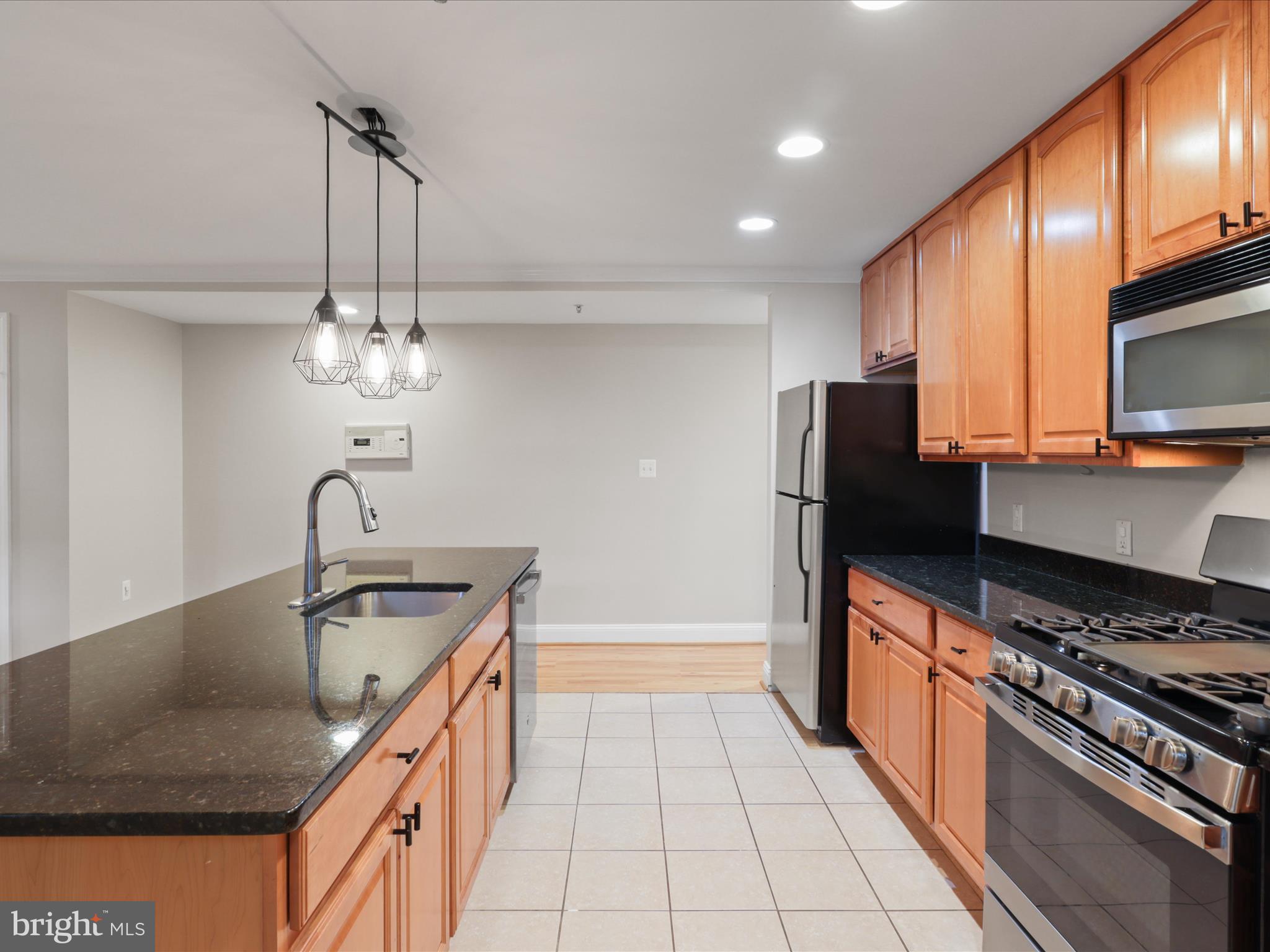 1300 Taylor Street Northwest, Unit 4 Washington, DC 20011 - Photo 13 of 35 a kitchen with stainless steel appliances granite countertop a sink a stove and a refrigerator