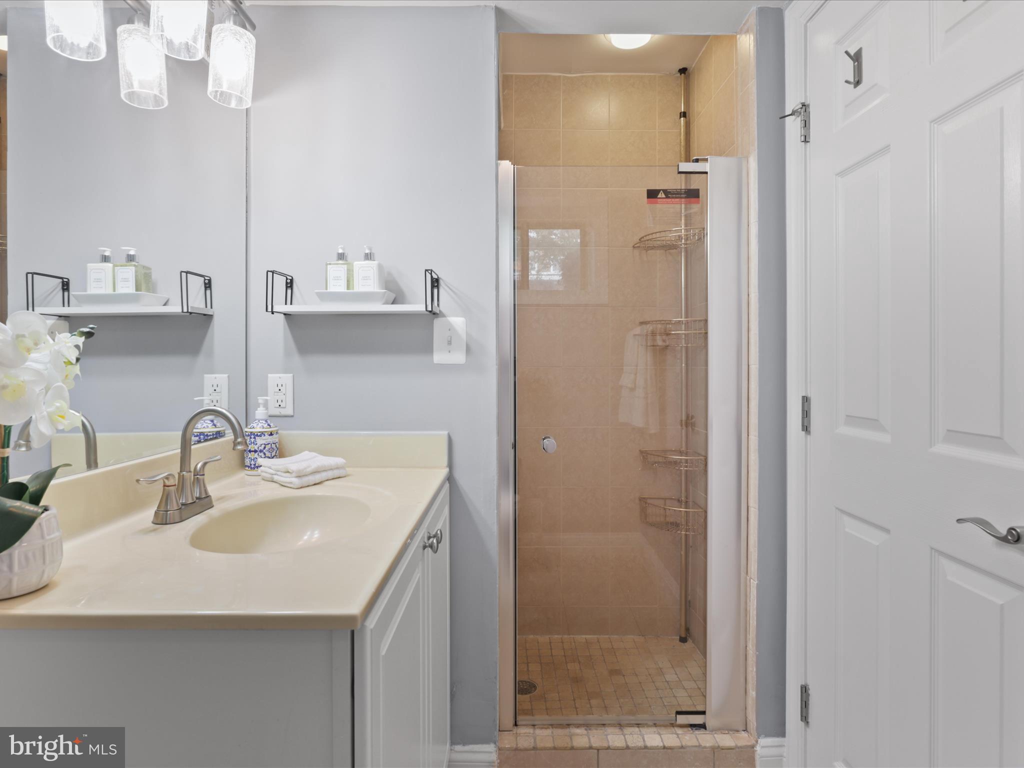 1300 Taylor Street Northwest, Unit 4 Washington, DC 20011 - Photo 19 of 35 a bathroom with a sink shower and a mirror