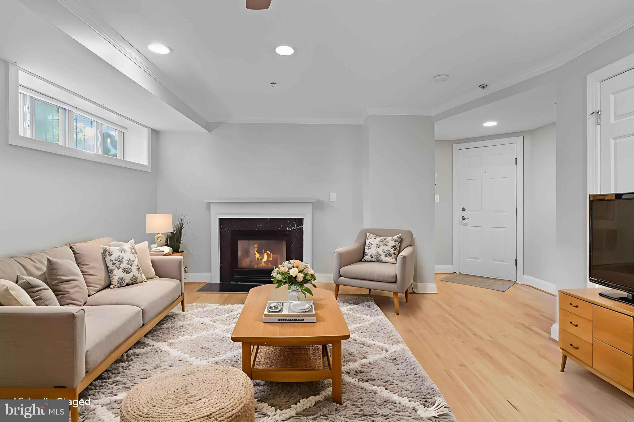 1300 Taylor Street Northwest, Unit 4 Washington, DC 20011 - Photo 5 of 35 a living room with furniture fireplace and a flat screen tv
