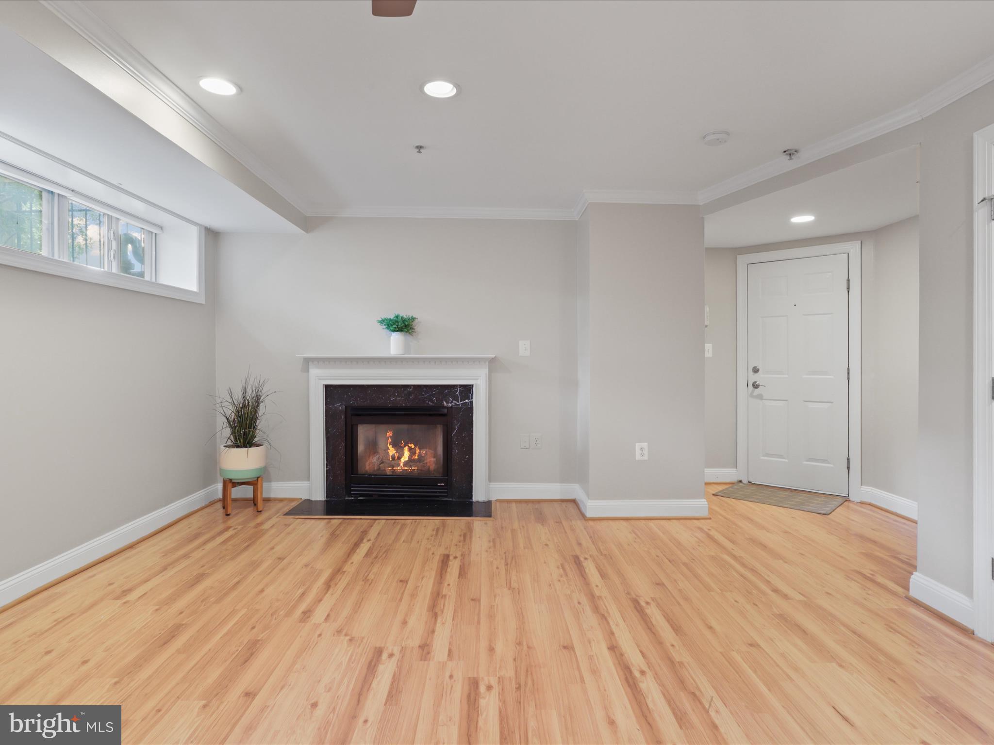 1300 Taylor Street Northwest, Unit 4 Washington, DC 20011 - Photo 7 of 35 a view of an empty room with a fireplace and a window