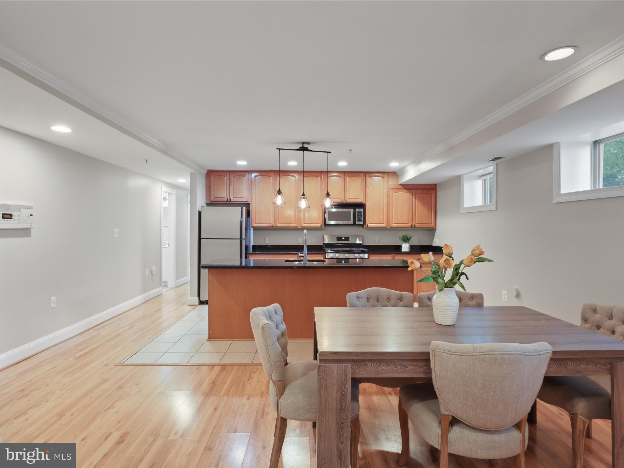1300 Taylor Street Northwest, Unit 4 Washington, DC 20011 - Photo 10 of 35 a dining room with furniture a window and kitchen view