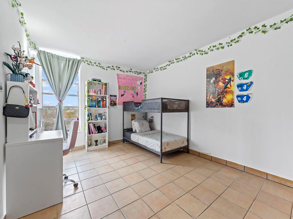310 Fontainebleau Boulevard, Unit 502 Miami, FL 33172 - Photo 11 of 24 a view of a kitchen with fridge and workspace