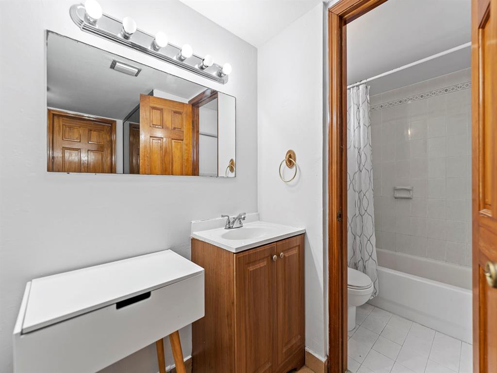 310 Fontainebleau Boulevard, Unit 502 Miami, FL 33172 - Photo 9 of 24 a bathroom with a sink a toilet and shower