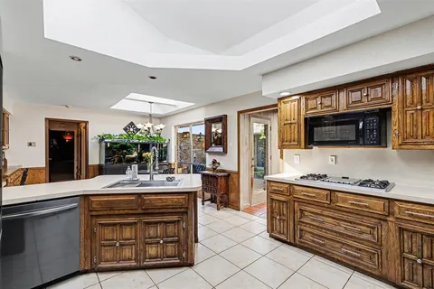 a kitchen with sink refrigerator and cabinets