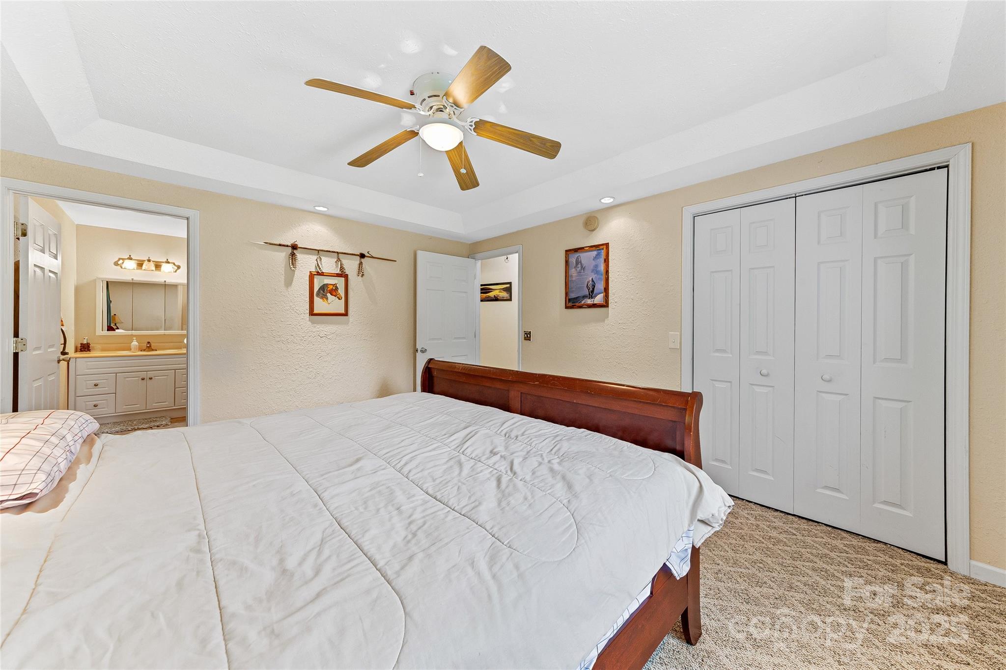 410 Lewis Road Rutherfordton, NC 28139 - Photo 17 of 23 a bedroom with a large bed and a chandelier