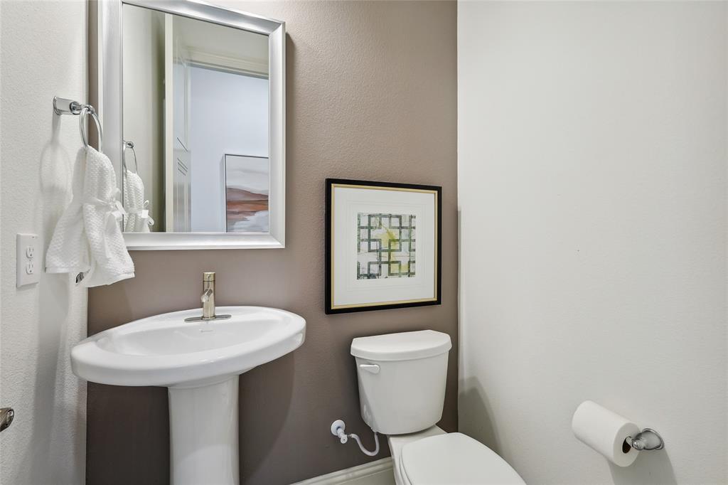 1604 Casting Ridge Mesquite, TX 75181 - Photo 16 of 38 Pedestal sink with polished chrome faucet, framed mirror, and two-tone wall finishes