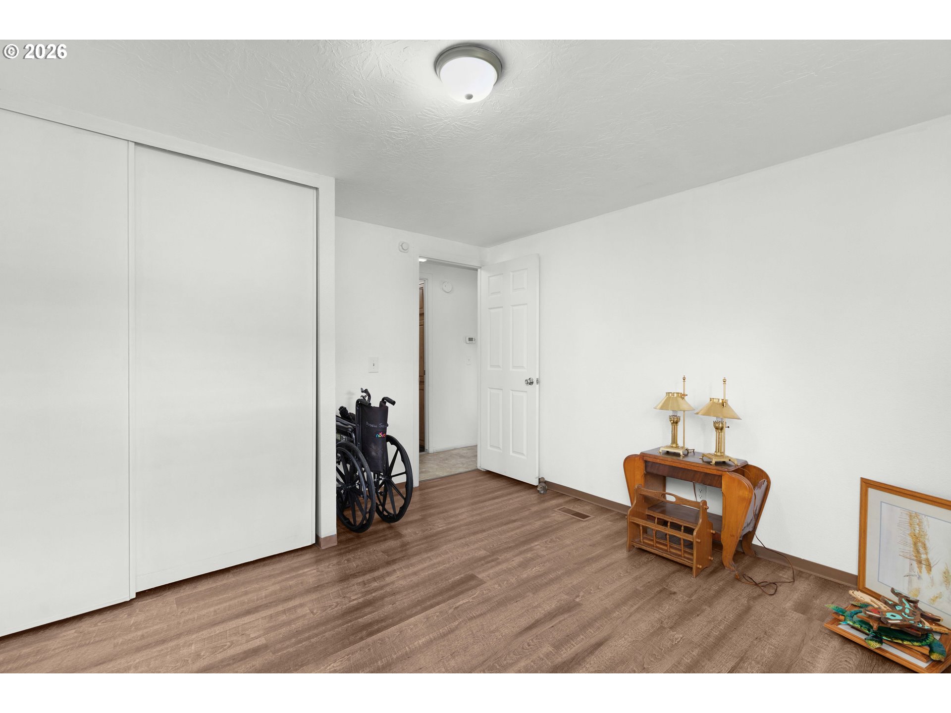 583 Suncrest Street Myrtle Creek, OR 97457 - Photo 17 of 24 a room with wooden floor and gym equipment
