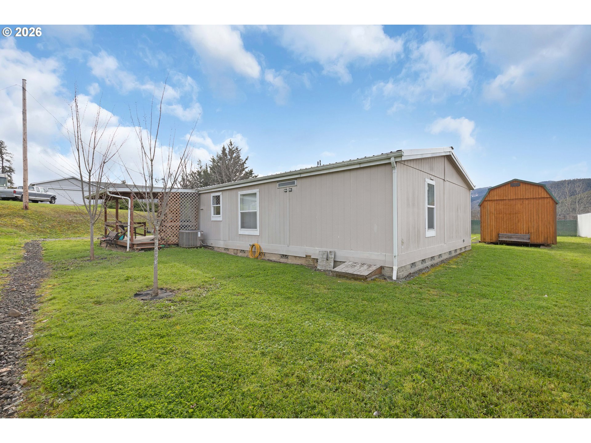 583 Suncrest Street Myrtle Creek, OR 97457 - Photo 20 of 24 a view of a backyard with potted plants and wooden fence