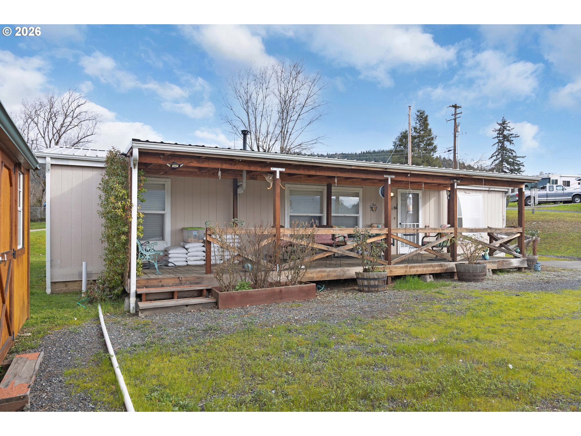 583 Suncrest Street Myrtle Creek, OR 97457 - Photo 2 of 24 a view of a house with backyard porch and sitting area